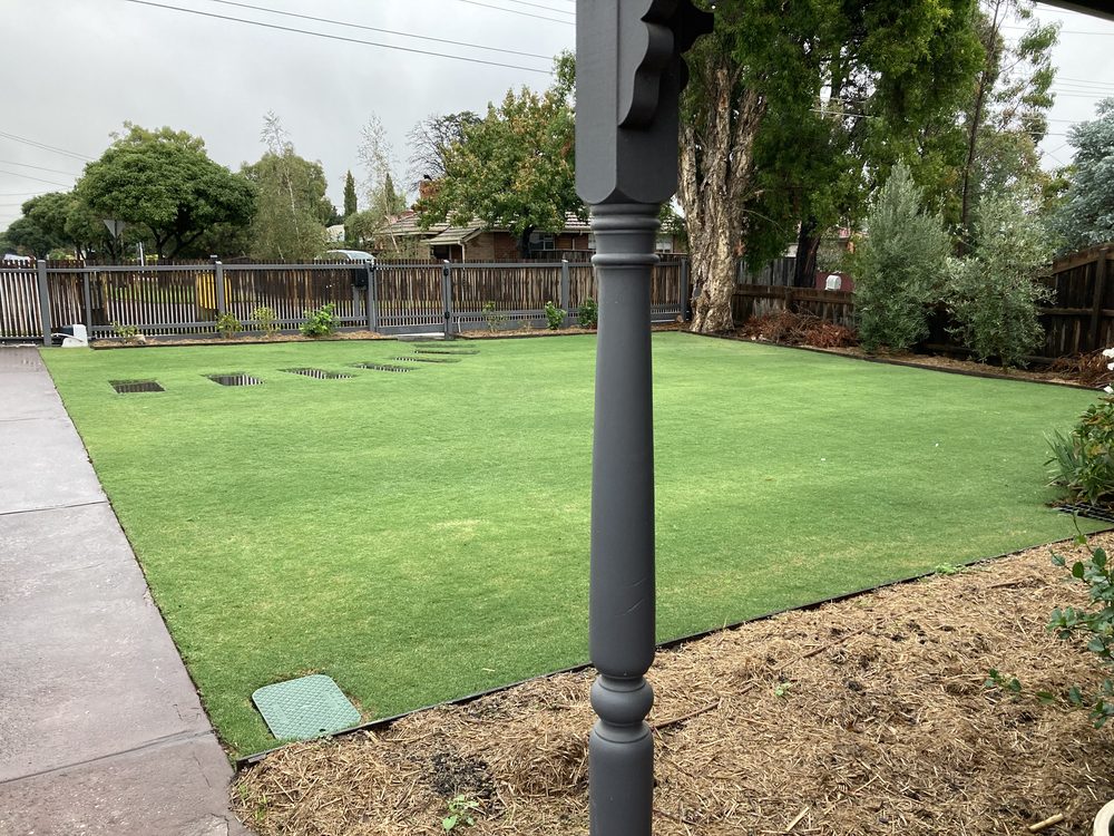 Freshly mown and maintained turf lawn in a landscaped residential backyard