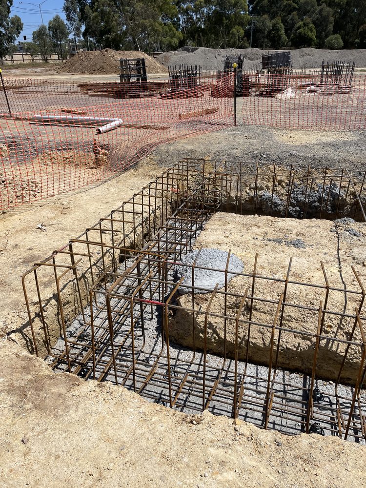 Reinforced concrete pad footings and steel cages on a civic earthworks site