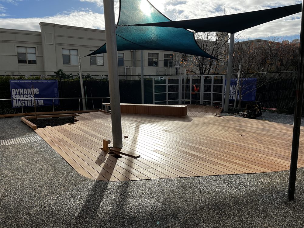 Completed timber deck with shade sails in a civic courtyard by Dynamic Spaces Australia