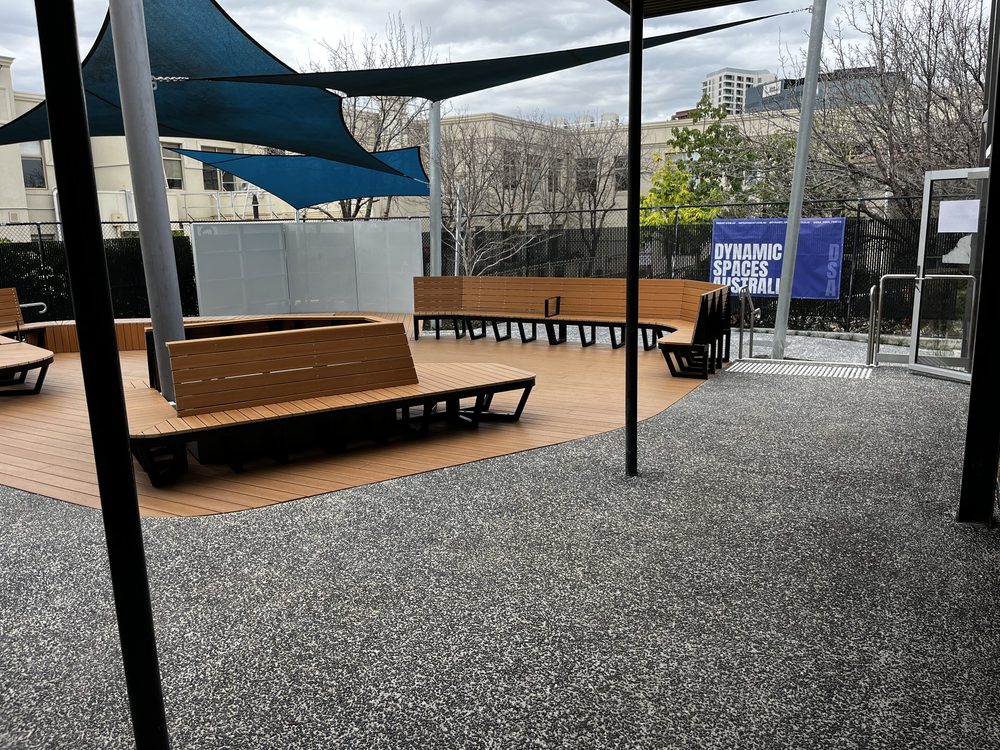 Composite deck with curved bench seating in a public courtyard